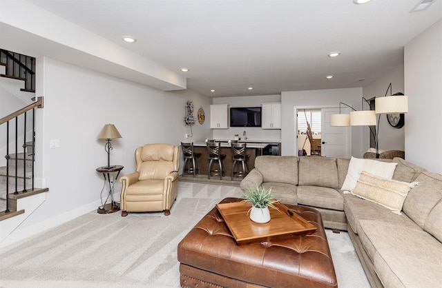 2426 SW Vineyard Ln, Ankeny, IA 50023 - living room with light carpet, wet bar, baseboards, recessed lighting, and stairs