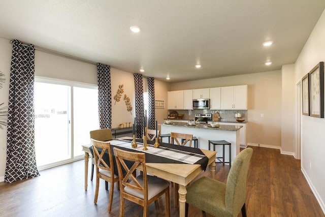 14521 Ironwood Ct, Urbandale, IA 50111 - dining area featuring dark wood-style flooring, baseboards, and recessed lighting