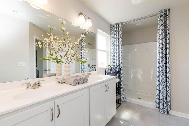 14521 Ironwood Ct, Urbandale, IA 50111 - full bath with a sink, visible vents, double vanity, and a shower with curtain