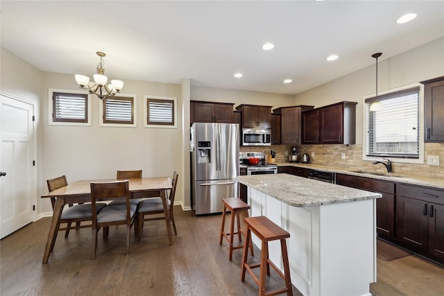 250 NE Fox Run Trl, Waukee, IA 50263 - kitchen featuring appliances with stainless steel finishes, a sink, dark brown cabinets, tasteful backsplash, and recessed lighting
