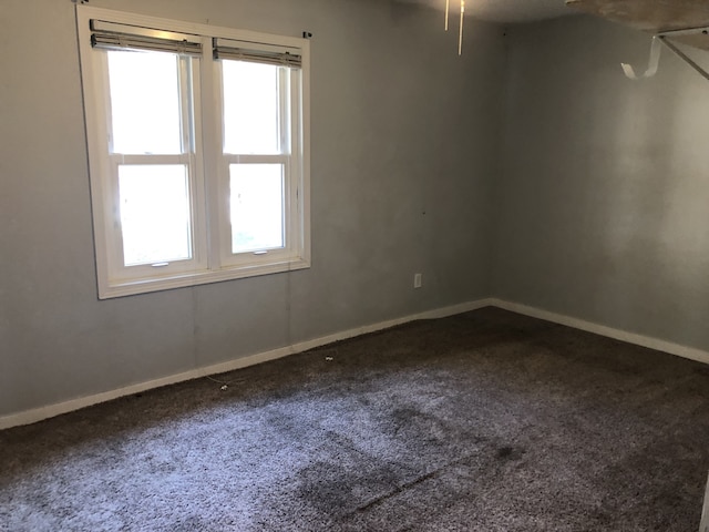 1032 69th St, Windsor Heights, IA 50324 - spare room featuring carpet floors and baseboards