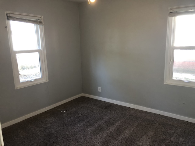 1032 69th St, Windsor Heights, IA 50324 - unfurnished room featuring dark carpet and plenty of natural light