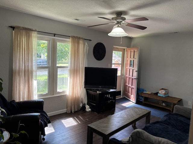 1032 69th St, Windsor Heights, IA 50324 - living room with healthy amount of natural light, a textured ceiling, a ceiling fan, and wood finished floors