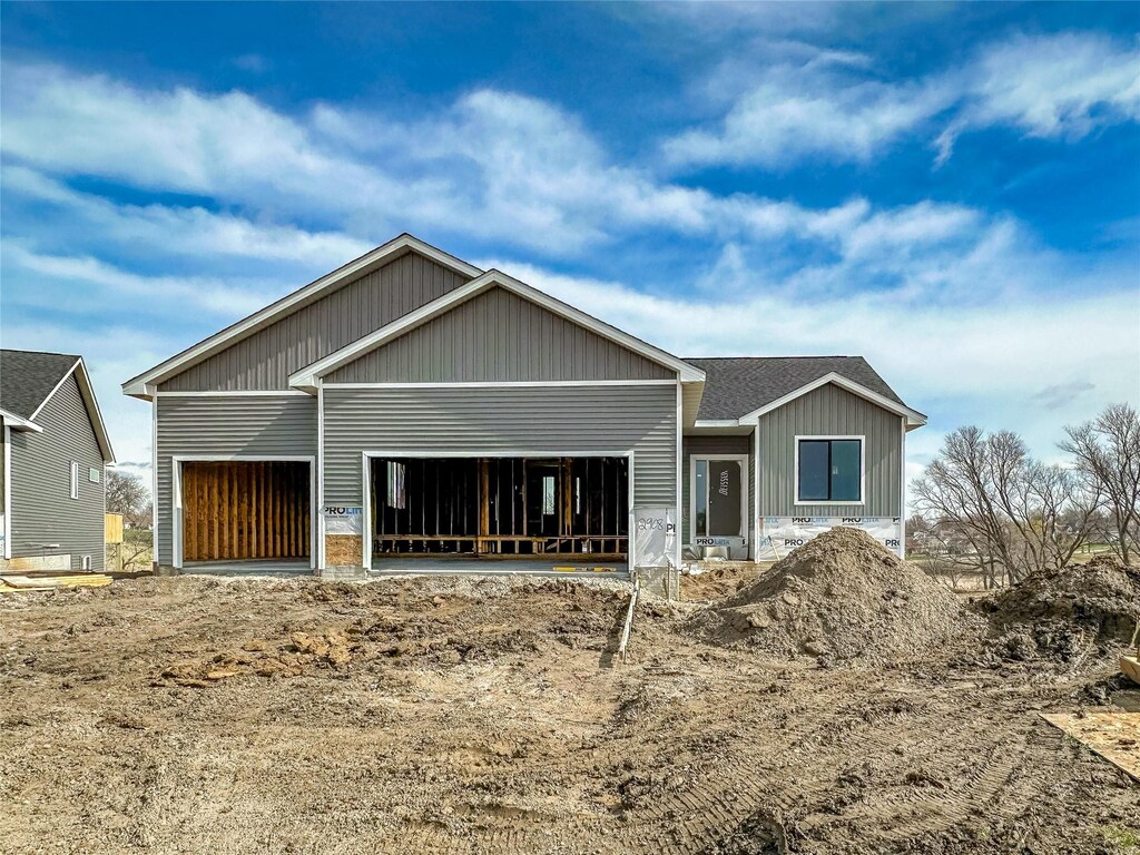 back of house featuring an attached garage and board and batten siding
