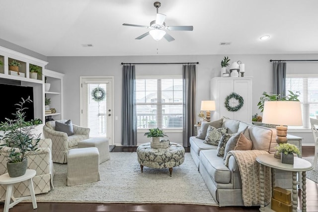 2403 NE Oak Dr Unit 6, Ankeny, IA 50021 - living area featuring visible vents, baseboards, a ceiling fan, wood finished floors, and lofted ceiling