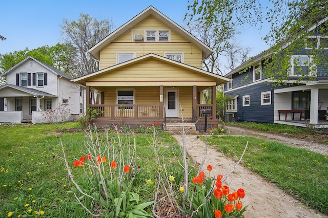 view of front of house with covered porch, cooling unit, and a front yard