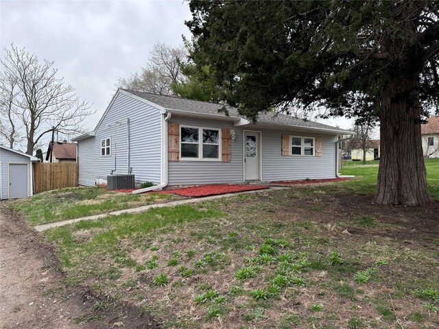 1402 E Marion St, Knoxville, IA 50138 - ranch-style home featuring roof with shingles, a garage, fence, and central AC