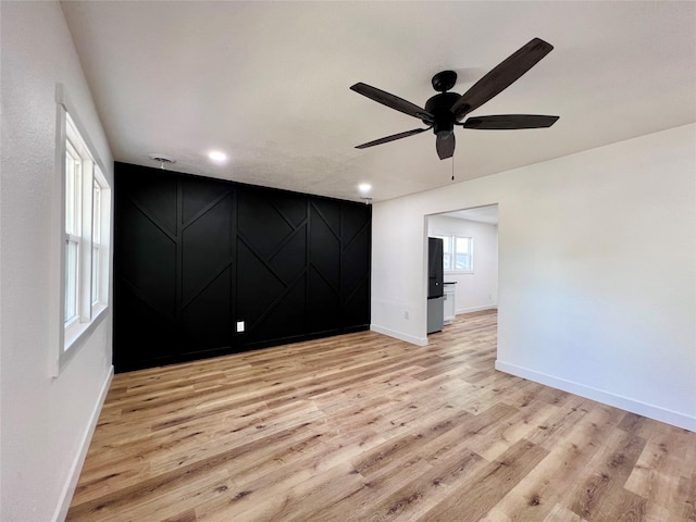 1402 E Marion St, Knoxville, IA 50138 - empty room with recessed lighting, light wood finished floors, baseboards, and a ceiling fan