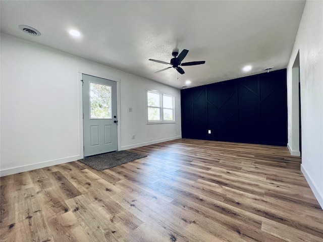 1402 E Marion St, Knoxville, IA 50138 - foyer entrance with visible vents, ceiling fan, baseboards, and wood finished floors