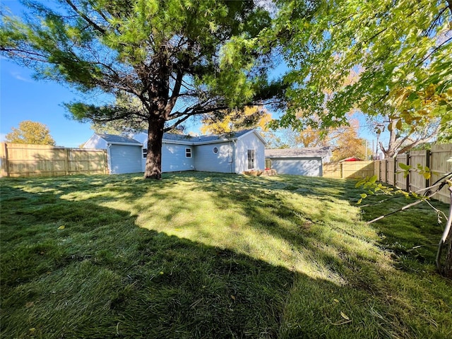 1402 E Marion St, Knoxville, IA 50138 - view of yard with a shed, a fenced backyard, and an outbuilding