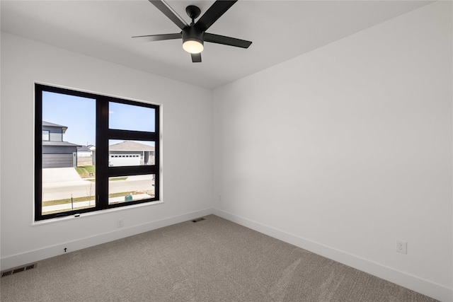 unfurnished room featuring visible vents, baseboards, and light carpet