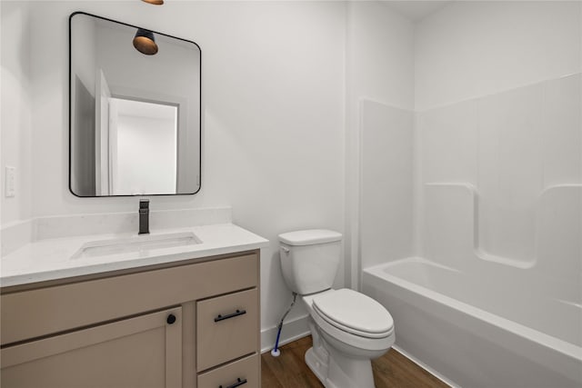 full bathroom with vanity, baseboards, toilet, and wood finished floors