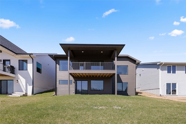 back of property with a lawn and a balcony