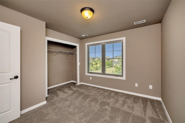 3555 NW 164th St, Clive, IA 50325 - unfurnished bedroom featuring carpet floors, a closet, and a textured ceiling