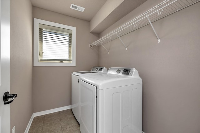 3555 NW 164th St, Clive, IA 50325 - laundry area featuring washing machine and clothes dryer and light tile patterned floors