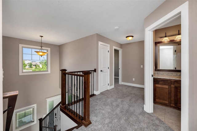 3555 NW 164th St, Clive, IA 50325 - hallway with an upstairs landing and light carpet