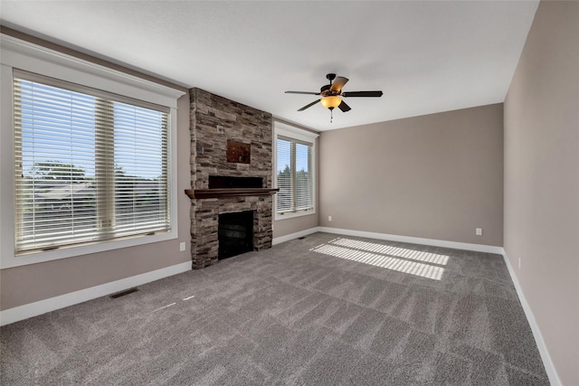 3555 NW 164th St, Clive, IA 50325 - unfurnished living room featuring ceiling fan, carpet floors, and a stone fireplace