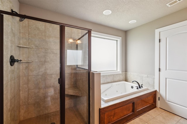 3555 NW 164th St, Clive, IA 50325 - full bath with a whirlpool tub, a stall shower, a textured ceiling, and tile patterned floors
