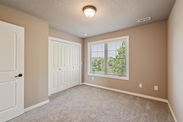 3555 NW 164th St, Clive, IA 50325 - unfurnished bedroom featuring carpet floors, a closet, and a textured ceiling