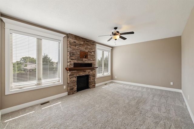 3555 NW 164th St, Clive, IA 50325 - unfurnished living room with ceiling fan, carpet flooring, a fireplace, and a textured ceiling
