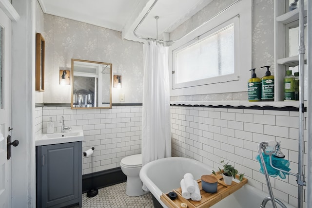 404 W Boston Ave, Indianola, IA 50125 - full bath featuring tile walls, a freestanding tub, tile patterned flooring, vanity, and wainscoting