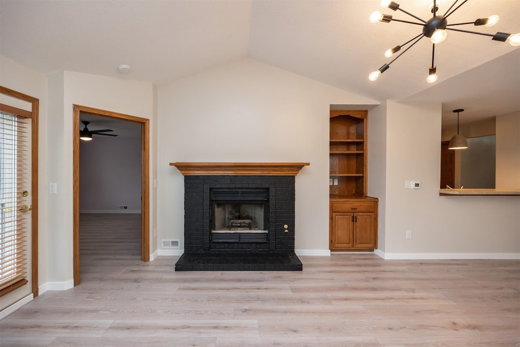 8142 Dellwood Dr, Urbandale, IA 50322 - unfurnished living room featuring vaulted ceiling, light wood finished floors, a fireplace, baseboards, and a chandelier