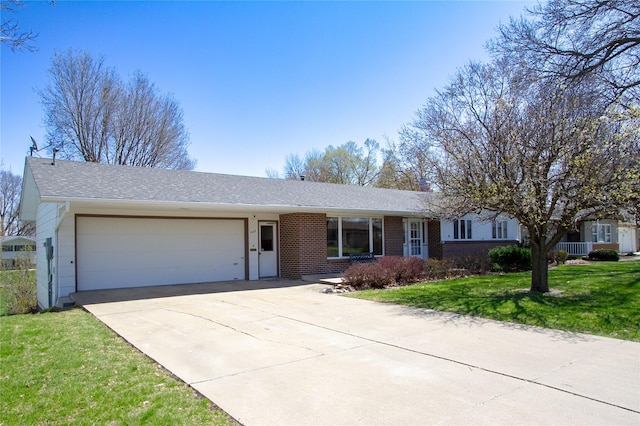 1412 Country Club Dr, Pella, IA 50219 - single story home featuring a garage, concrete driveway, brick siding, a front lawn, and roof with shingles