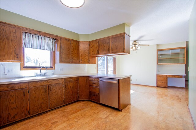 1412 Country Club Dr, Pella, IA 50219 - kitchen with stainless steel dishwasher, brown cabinetry, and light countertops