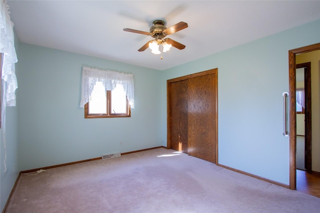 1412 Country Club Dr, Pella, IA 50219 - unfurnished bedroom featuring carpet floors, a closet, baseboards, and ceiling fan