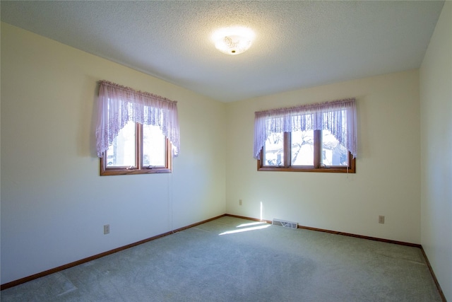 1412 Country Club Dr, Pella, IA 50219 - unfurnished room featuring carpet, baseboards, and a textured ceiling