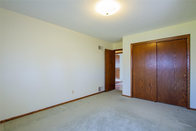 1412 Country Club Dr, Pella, IA 50219 - unfurnished bedroom with light colored carpet, a closet, and baseboards