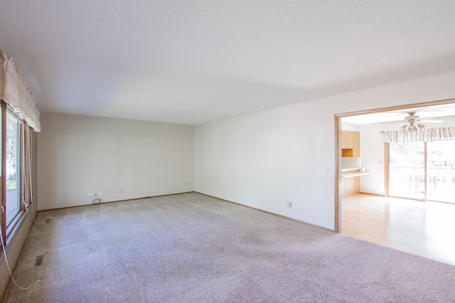 1412 Country Club Dr, Pella, IA 50219 - spare room with carpet floors, a ceiling fan, and baseboards