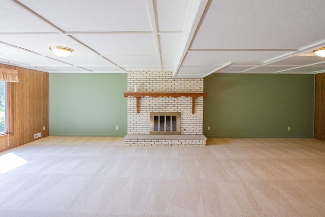 1412 Country Club Dr, Pella, IA 50219 - unfurnished living room featuring carpet floors, baseboards, a brick fireplace, and wooden walls
