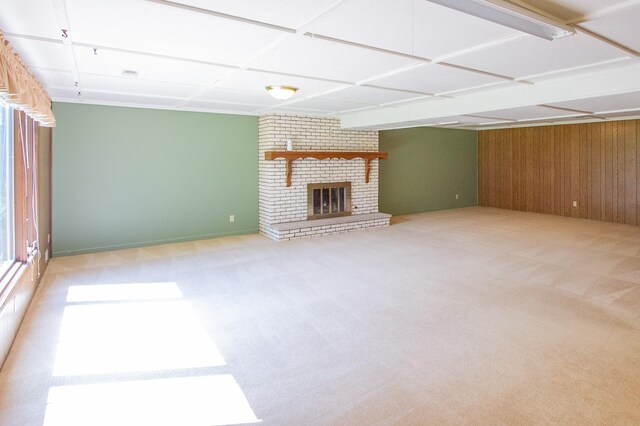 1412 Country Club Dr, Pella, IA 50219 - unfurnished living room with carpet floors, wood walls, and a brick fireplace