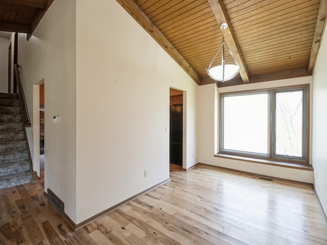 interior space featuring light wood finished floors, stairway, vaulted ceiling with beams, and wooden ceiling
