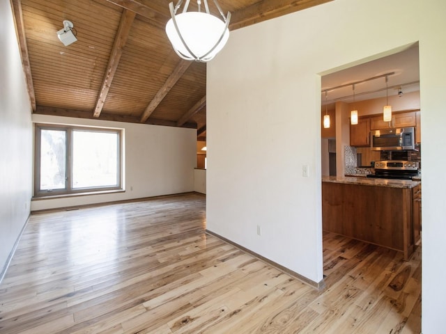 unfurnished living room with vaulted ceiling with beams, wood ceiling, track lighting, light wood finished floors, and baseboards
