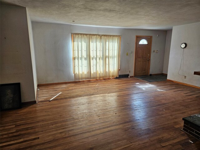 entryway featuring baseboards and wood finished floors