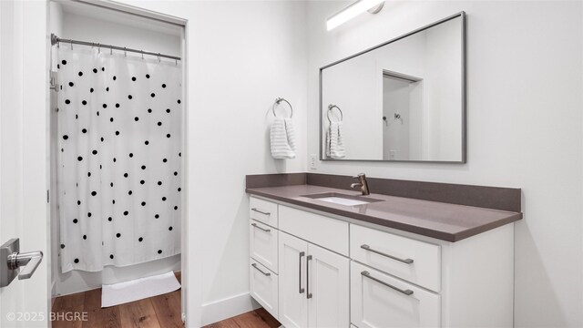 18170 79th Ln, Indianola, IA 50125 - full bathroom with vanity and wood finished floors