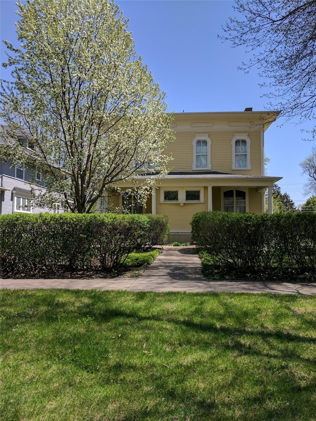 view of front of house with a front lawn and a chimney