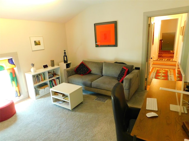 living room featuring carpet floors and lofted ceiling