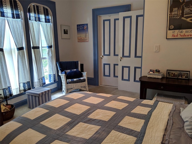 bedroom featuring light carpet