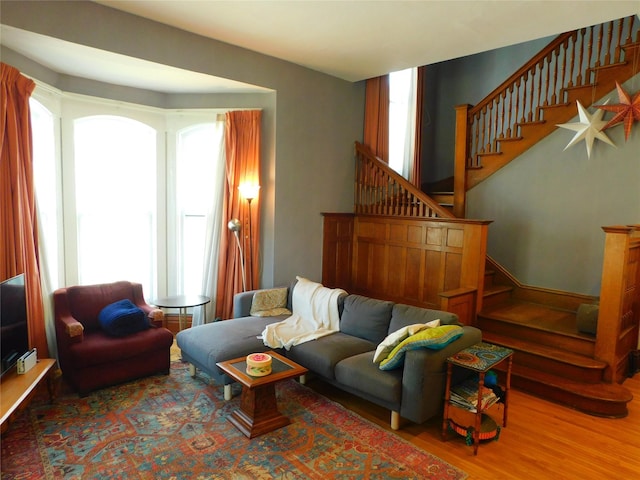 living room with a healthy amount of sunlight and stairs