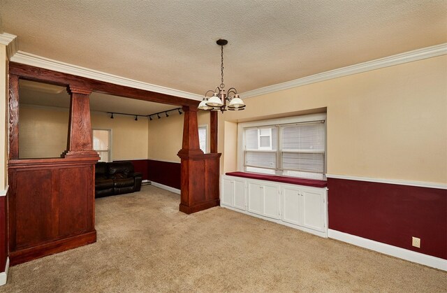 1632 Mamie Eisenhower Ave, Boone, IA 50036 - empty room featuring a chandelier, light carpet, crown molding, baseboards, and a textured ceiling