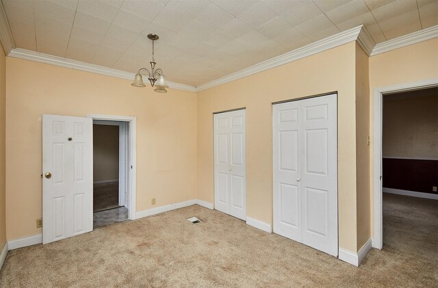 1632 Mamie Eisenhower Ave, Boone, IA 50036 - unfurnished bedroom featuring carpet floors, ornamental molding, two closets, a chandelier, and baseboards