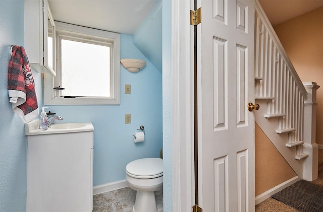 1632 Mamie Eisenhower Ave, Boone, IA 50036 - bathroom with toilet, vanity, and baseboards