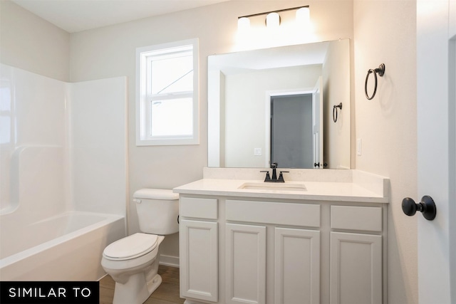 full bathroom featuring toilet, wood finished floors, vanity, and tub / shower combination