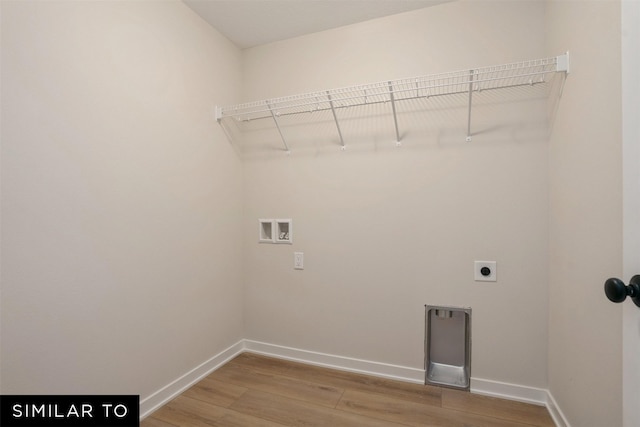 washroom with baseboards, light wood-style floors, laundry area, electric dryer hookup, and hookup for a washing machine