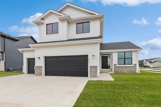 modern farmhouse featuring concrete driveway, stone siding, board and batten siding, a front lawn, and a garage
