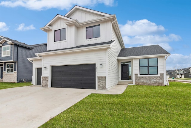 view of front of house with an attached garage, stone siding, board and batten siding, a front lawn, and driveway