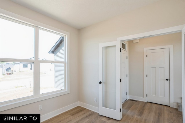 interior space with light wood-style flooring and baseboards